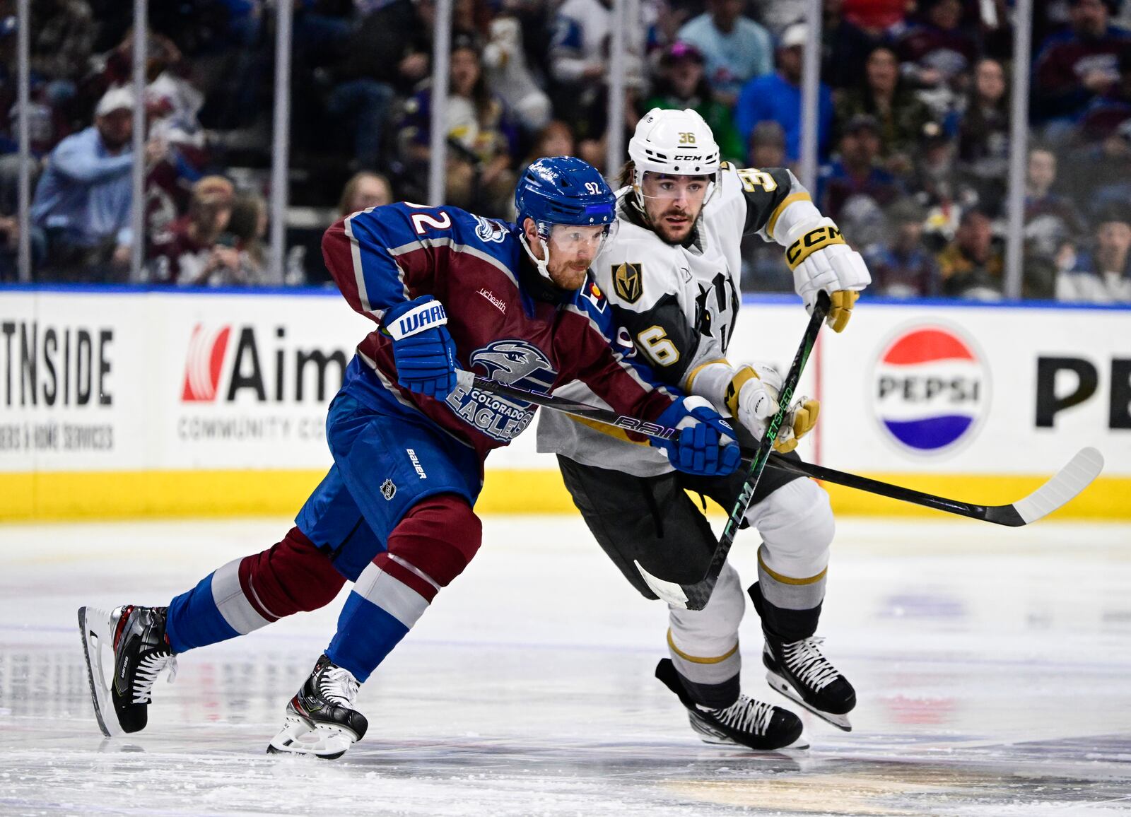 Colorado Eagles forward Gabriel Landeskog, left, battles for position with Henderson Silver Knights forward Raphael Lavoie in the first period of a minor league hockey game Friday, April 11, 2025, in Loveland, Colo. (Andy Cross/The Denver Post via AP)