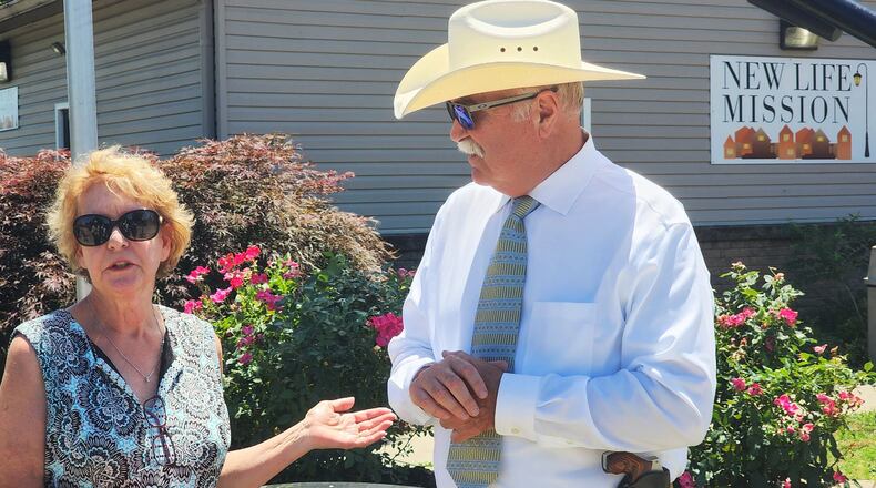 Butler County Clerk of Courts Mary Swain, left, and Butler County Sheriff Richard K. Jones did a Facebook live to help bring awareness to the needs and raise money for New Life Mission on Henry Street in Hamilton. The mission is raising money for a new air conditioner and other repairs for the building. New Life Mission provides meals and food pantry items and serves as an outreach hub for many in need in the area. NICK GRAHAM/STAFF