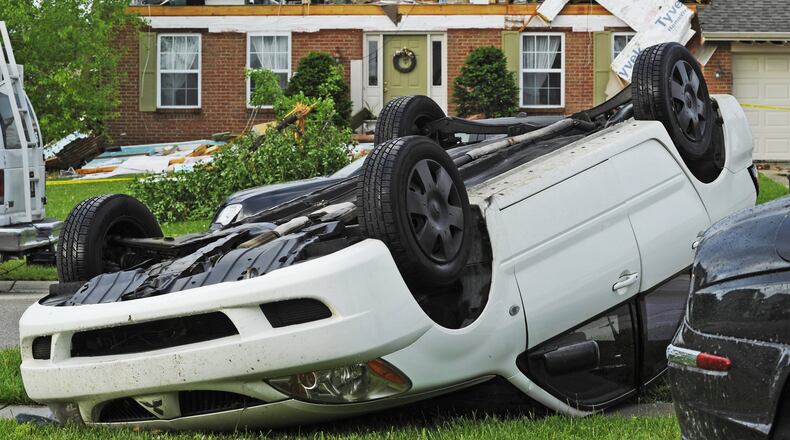 A roof and much of the second story of a home on Glen Hollow Drive ripped off and a car was flipped over due to a high winds overnight Thursday, May 26, 2011 in Liberty Twp. in Butler County. Several other homes were damaged and trees were ripped from the ground in the neighborhood. NICK GRAHAM/FILE