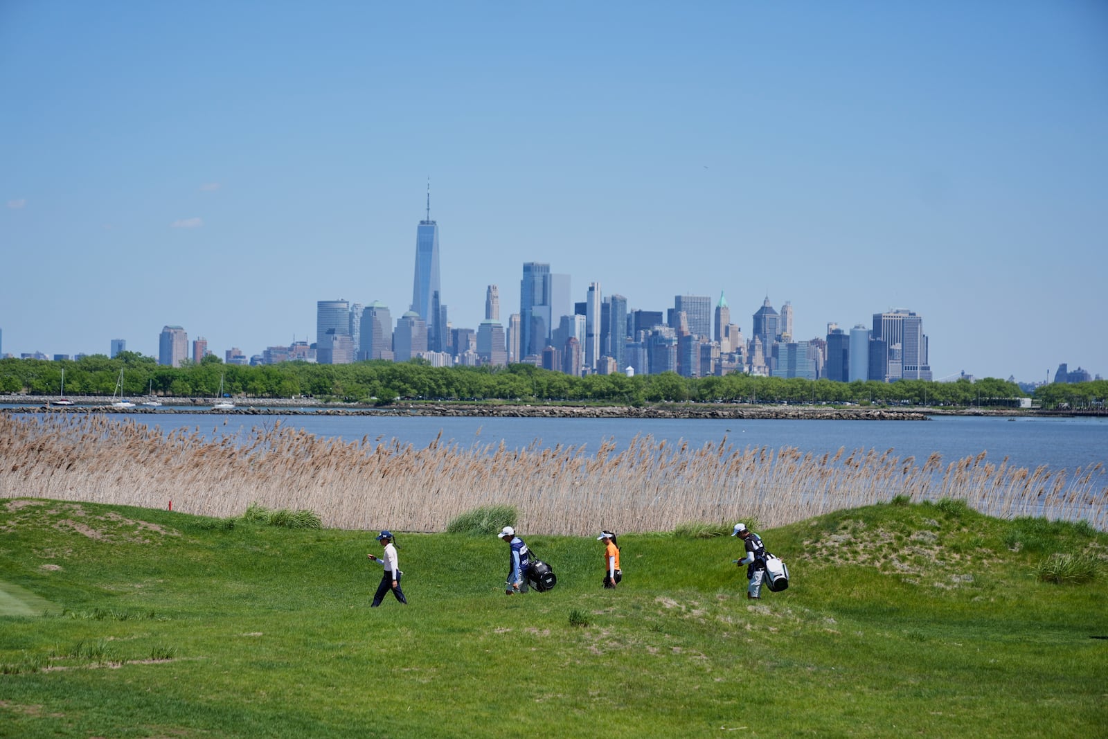 Jeeno Thitikul, of Thailand, second right, and Celine Boutier, of France, left, walk on the 14th hole during the final round of the Mizuho Americas Open LPGA golf tournament, Sunday, May 11, 2025, in Jersey City, N.J. (AP Photo/Seth Wenig)