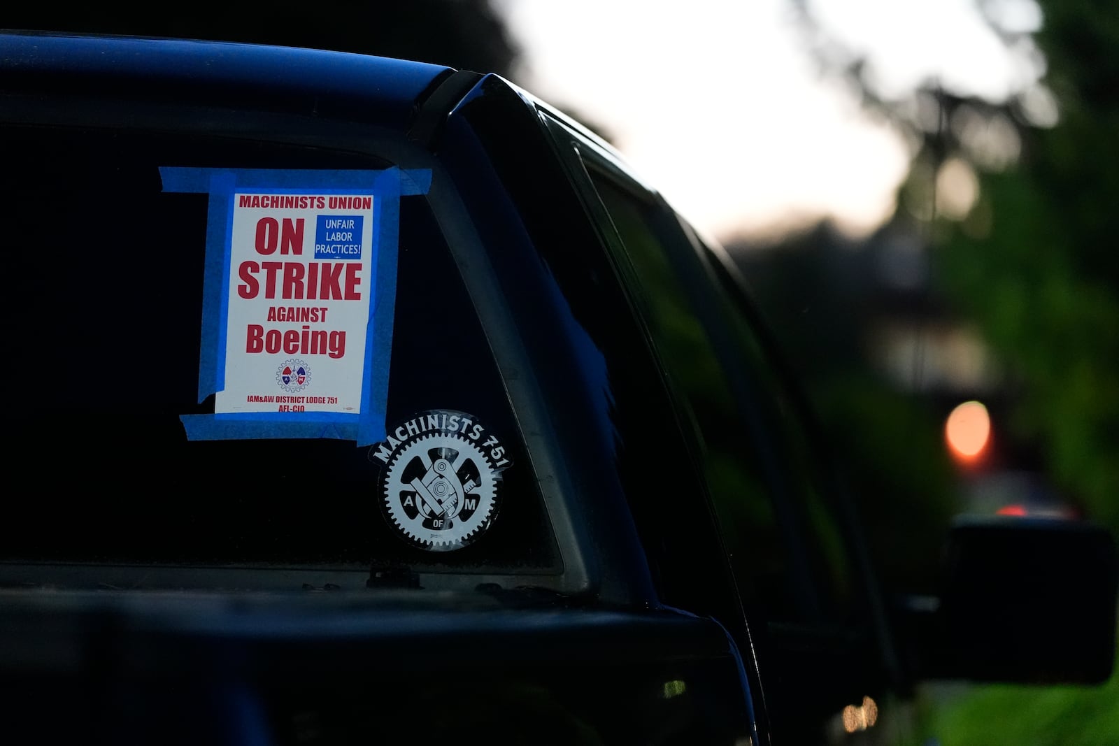 FILE - A truck displays a small strike sign in the parking lot of the Aerospace Machinists Union hall as Boeing employees arrive to vote on a new contract offer from the company, Nov. 4, 2024, in Renton, Wash. (AP Photo/Lindsey Wasson, file)