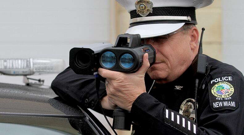 New Miami Police Chief Dan Gilbert demonstrates Monday, Dec. 21, 2015, the new hand held speed cameras. CONTRIBUTED/E.L. HUBBARD