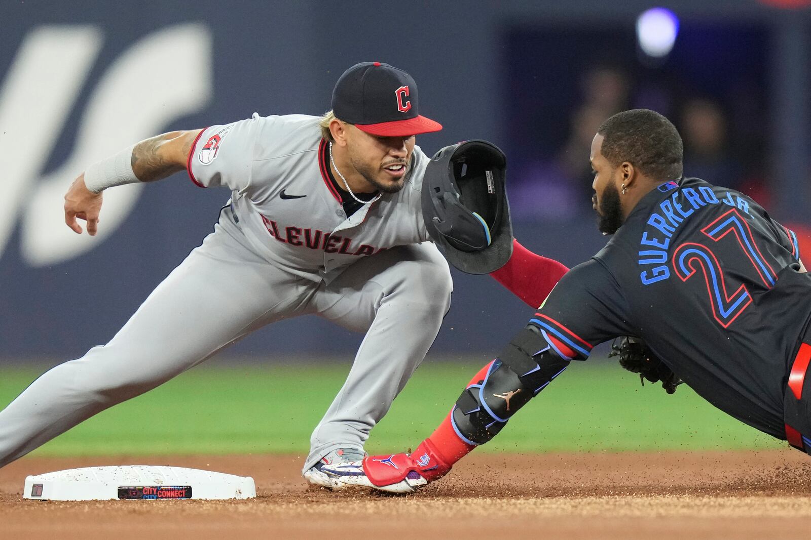 Toronto Blue Jays' Vladimir Guerrero Jr. is tagged out at second base by Cleveland Guardians second baseman Gabriel Arias during the first inning of a baseball game in Toronto on Friday, May 2, 2025. (Chris Young/The Canadian Press via AP)