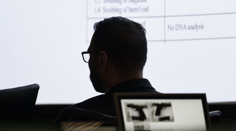 Gurpreet Singh, accused of killing four family members in 2019 at his West Chester Twp. home, watches evidence of the murder weapon displayed in court on Monday during is retrial. NICK GRAHAM/STAFF