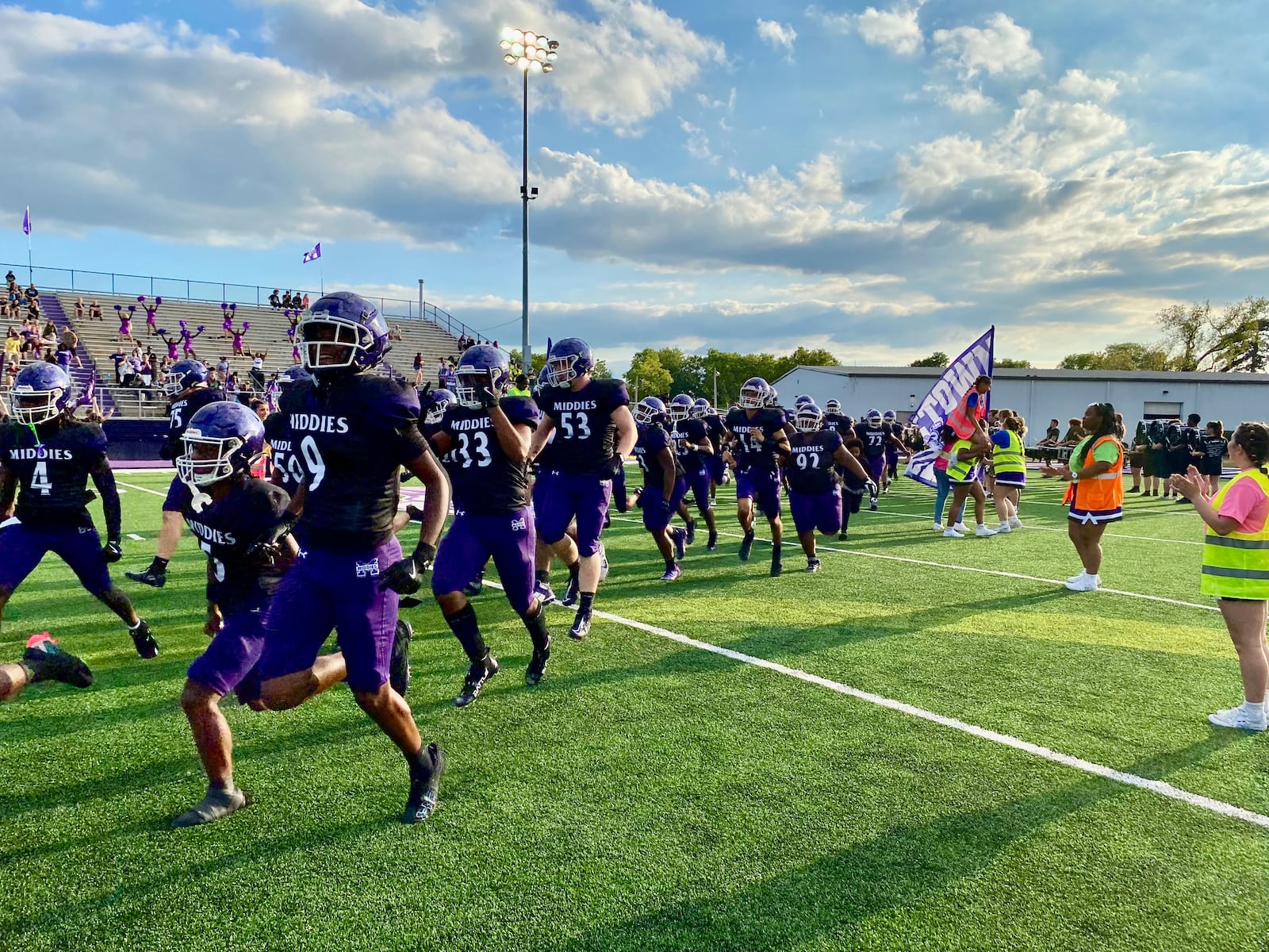 An excited crowd saw the unveiling Friday night of Middletown Schools’ new $750,000 football field at its team's season home opener at Barnitz Stadium.
The Middletown High School football Middies took on the Troy High School football squad but the dazzling new synthetic turf and its colorful graphics shared the spotlight in what school officials described as more than a prep sporting event. (Photo By Michael D. Clark/Journal-News)