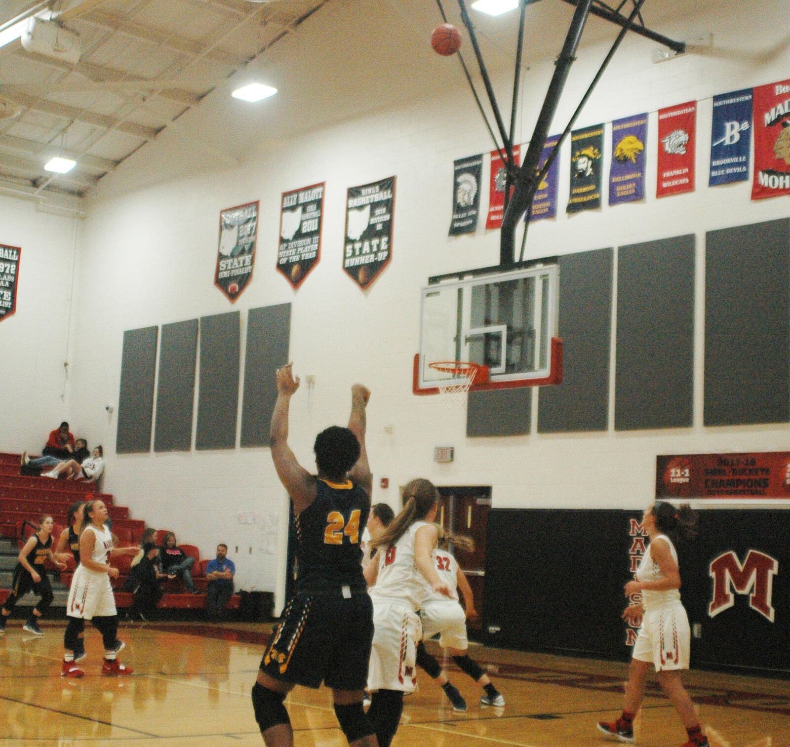 Monroe’s Olivia Wells-Daniels (24) watches the flight of a successful 3-pointer during Thursday night’s 50-39 victory at Madison. RICK CASSANO/STAFF