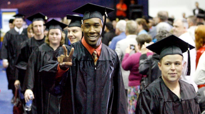 Graduates look for family and friends during the recessional at Urbana University's commencement on Saturday, May 3, 2008.