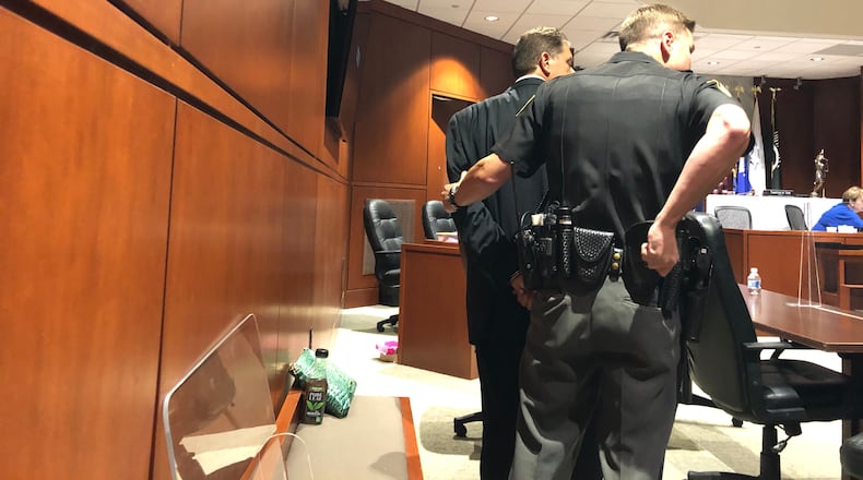 Timothy Hall, 57, of Clearcreek Twp., is handcuffed and led off to jail after being convicted Friday in Warren County Common Pleas Court.