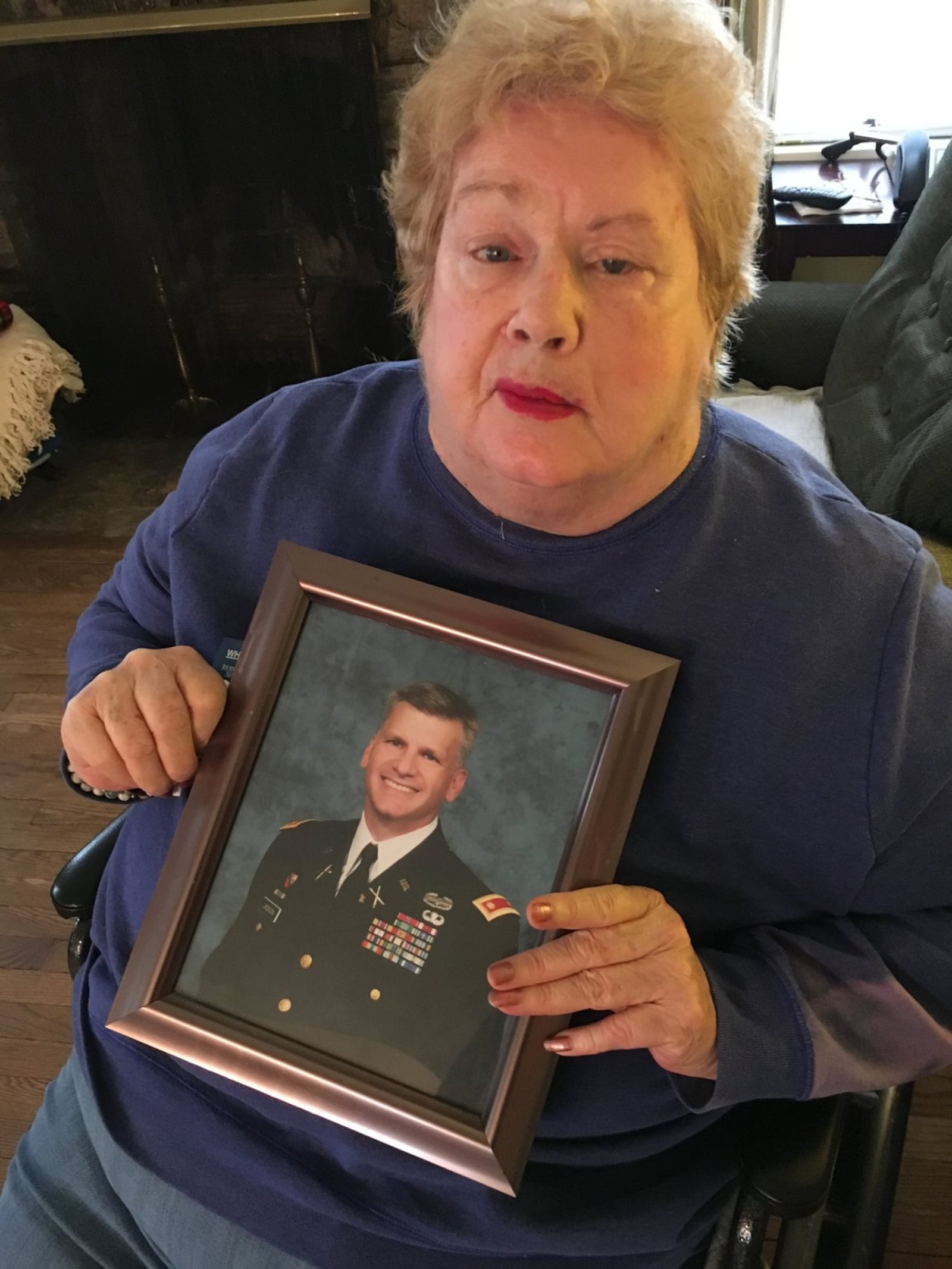 Rosaland Jackson, 77, of Middletown, holds a photo of her son, Lt. Col. Joe Jackson. Someone recently stole several items from the Jacksons while he was in Afghanistan.