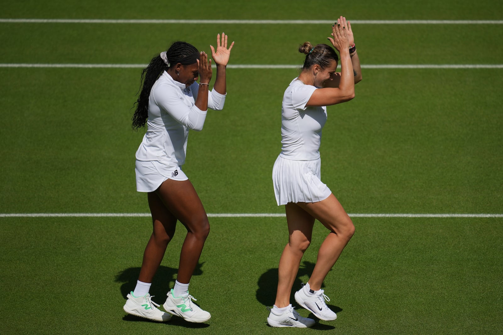 Aryna Sabalenka of Belarus, right, and Coco Gauff of United States during a practice session ahead of the Wimbledon Championships in London, Friday, June 27, 2025. (AP Photo/Kin Cheung)