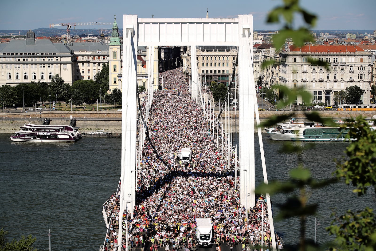 Participants in the Pride march cross the Elisabeth Bridge in Budapest, Hungary, Saturday, June 28, 2025. (AP Photo/Rudolf Karancsi)