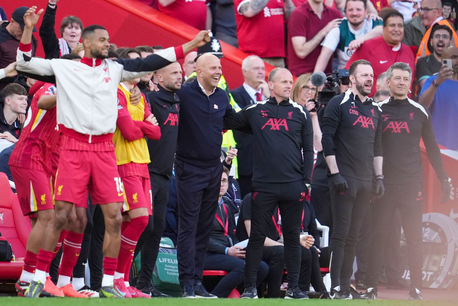 Liverpool's manager Arne Slot, center, celebrates after winning the English Premier League soccer match between Liverpool and Tottenham Hotspur and clinching the Premier League title at Anfield in Liverpool, England, Sunday, April 27, 2025. (AP Photo/Jon Super)