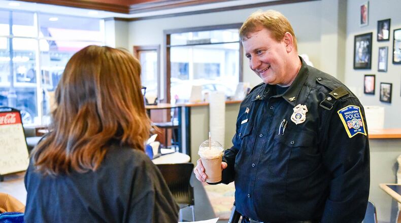 Middletown Police Chief David Birk talks to resident Liz Martin during coffee with the chief Tuesday, Jan. 28 at Triple Moon Coffee on Central Avenue in Middletown. NICK GRAHAM / STAFF