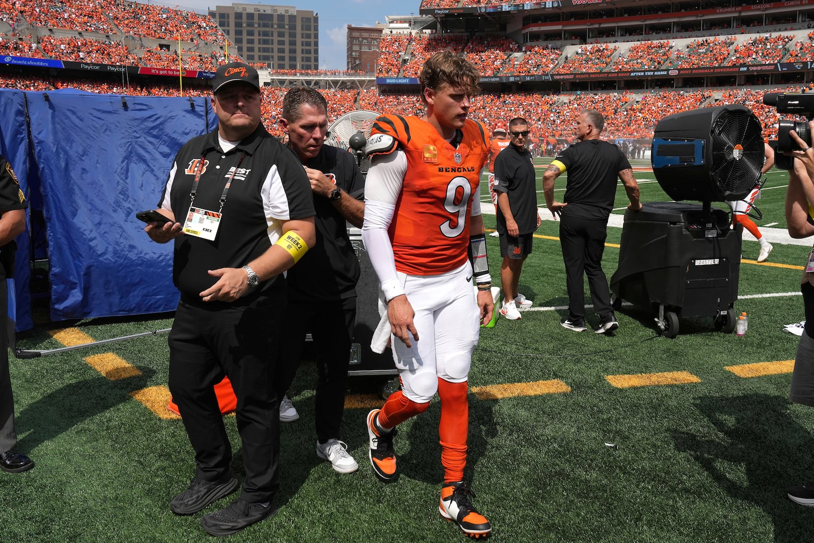 FILE - Cincinnati Bengals quarterback Joe Burrow, center, is exits the medical tent for the locker room after suffering an injury during the second quarter of an NFL football game against the Jacksonville Jaguars, Sept. 14, 2025, in Cincinnati. (AP Photo/Kareem Elgazzar, File)