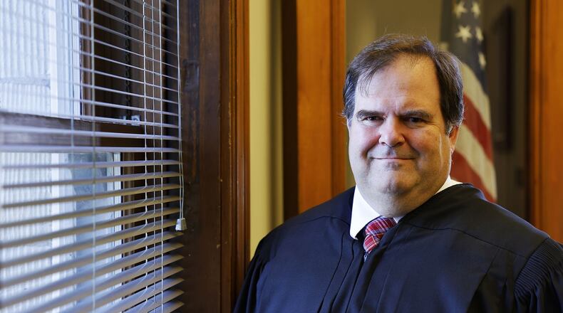 Butler County Probate Judge John M. Holcomb in his court room in the historic Butler County Courthouse Aug. 31, 2022 in Hamilton. Holcomb is using $24,500 out of his special revenue fund to give his employees increases to their base salaries. NICK GRAHAM/STAFF