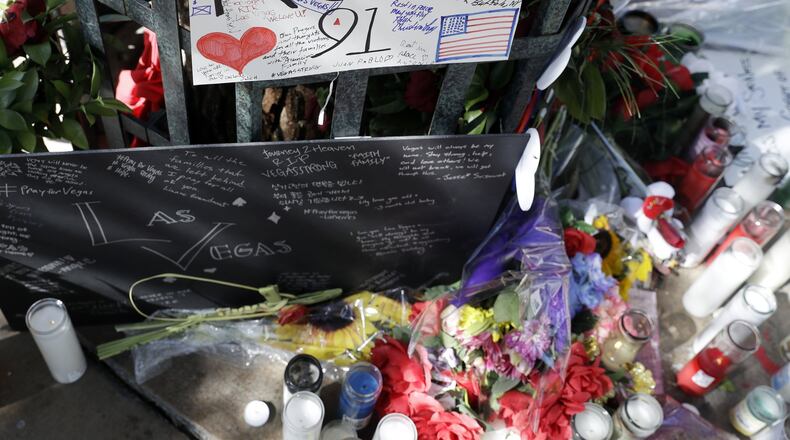 Flowers and signs are left at a memorial for the victims of a mass shooting in Las Vegas, Wednesday, Oct. 4, 2017, in Las Vegas. A gunman opened fire on an outdoor music concert on Sunday killing dozens and injuring hundreds. (AP Photo/Marcio Jose Sanchez)