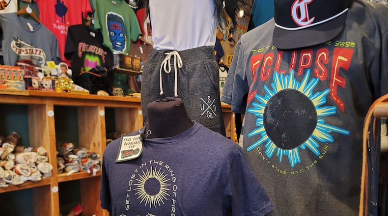 Many businesses in the area have eclipse merchandise like these shirts at Unsung Salvage Design Company in Hamilton. NICK GRAHAM/STAFF