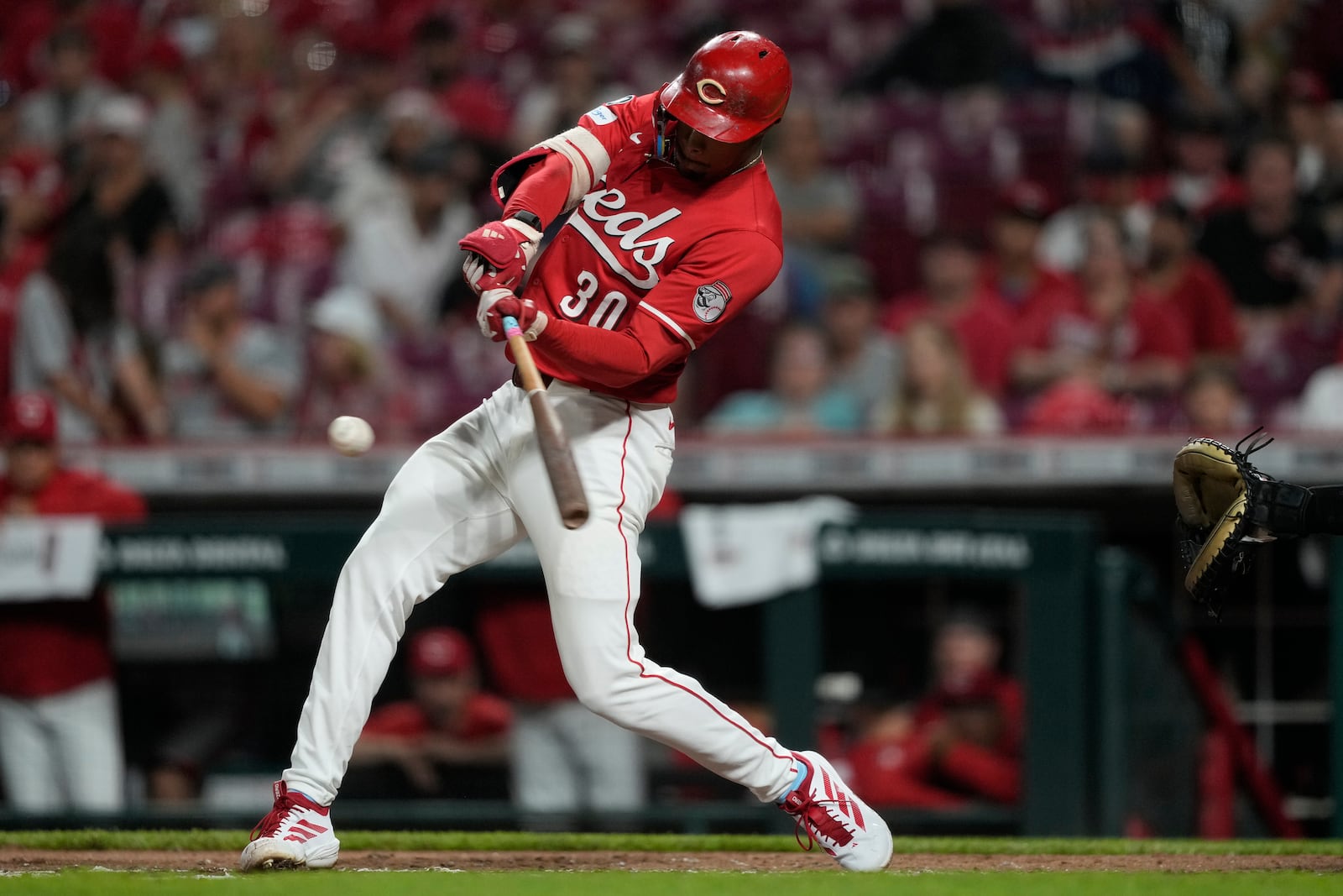 Cincinnati Reds' Will Benson hits a single to score Trevor Larnach in the third inning of a baseball game against the Minnesota Twins, Wednesday, June 18, 2025, in Cincinnati. (AP Photo/Carolyn Kaster)