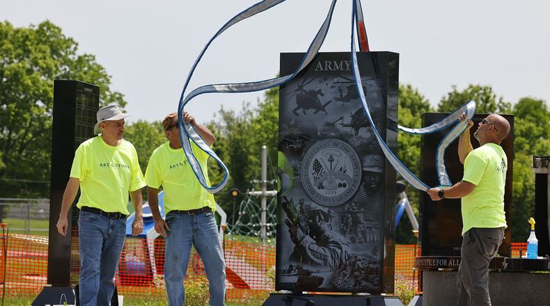 A crew from Art & Stone Monument Company installs a monument of the Fairfield Twp. Veterans Memorial at Heroes Park. A dedication of the completed memorial will be held at 1 p.m. on June 3. NICK GRAHAM/STAFF
