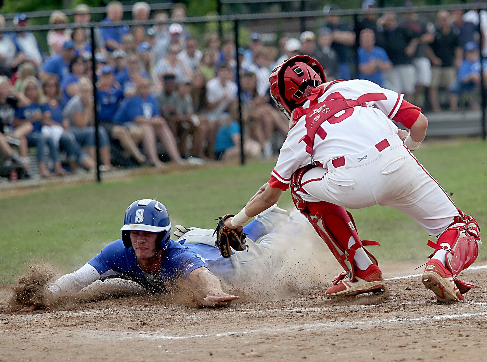 Springboro’s Justin McConnell slides under the tag of Lakota West catcher Chase Wullenweber on Saturday during a Division I district final at Centerville. CONTRIBUTED PHOTO BY E.L. HUBBARD
