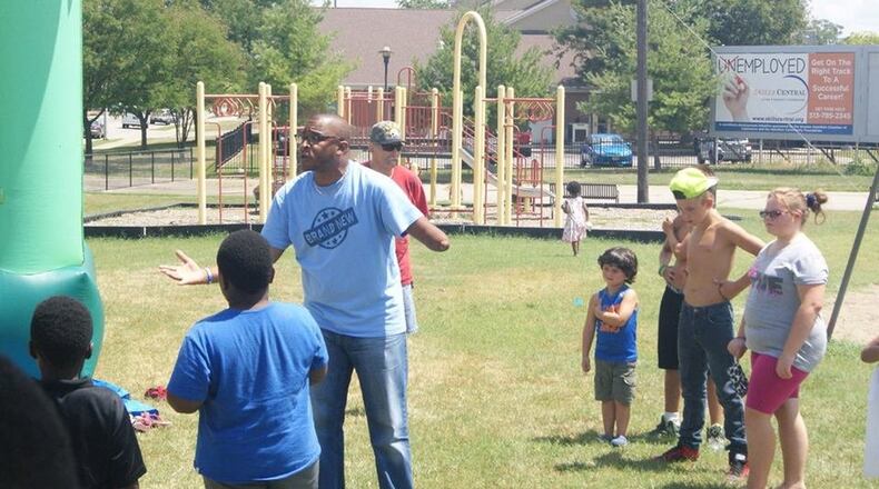 New Day Baptist Church Pastor Mike Pearl talks with youth during a school supply giveaway. Pearl says the church has a duty to reach out and try to get kids to steer clear of drug abuse. CONTRIBUTED