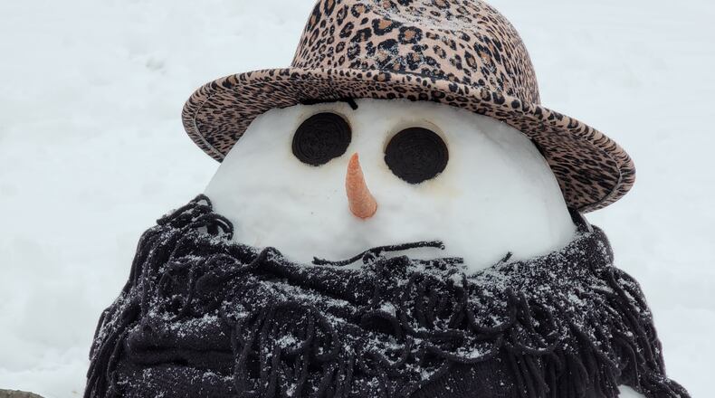 Local children built snowmen Tuesday at The Woodlands of Hamilton assisted living and memory-care live-in community. NICK GRAHAM / STAFF