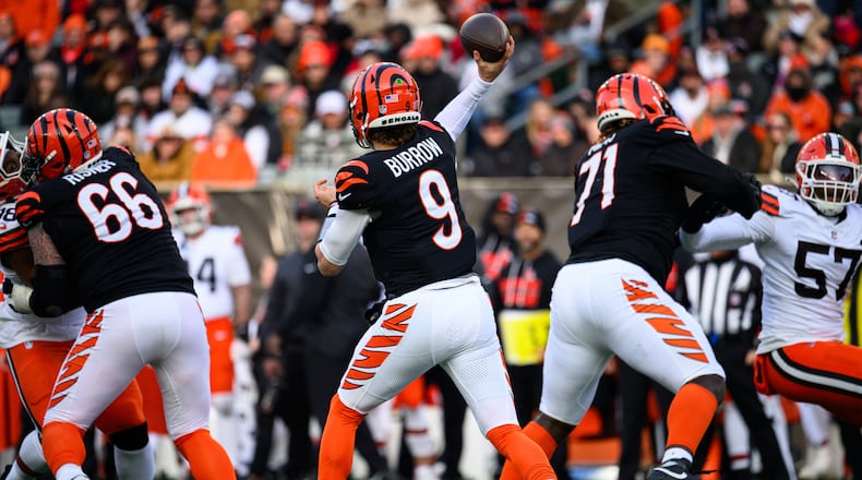 Cincinnati Bengals quarterback Joe Burrow passes the ball with protection from offensive linemen Dalton Risner (left) and Amarius Mims during their game against the Cleveland Browns on Sunday, Jan. 4, 2026 at Paycor Stadium. JEREMY MILLER / CONTRIBUTED PHOTO