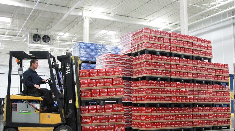A warehouse operations worker at Heidelberg Distributing moves pallets of beer in July 2013 inside the company’s then-new distribution center in the former Cooper Tire building in Moraine. FILE PHOTO BY CHRIS STEWART / STAFF
