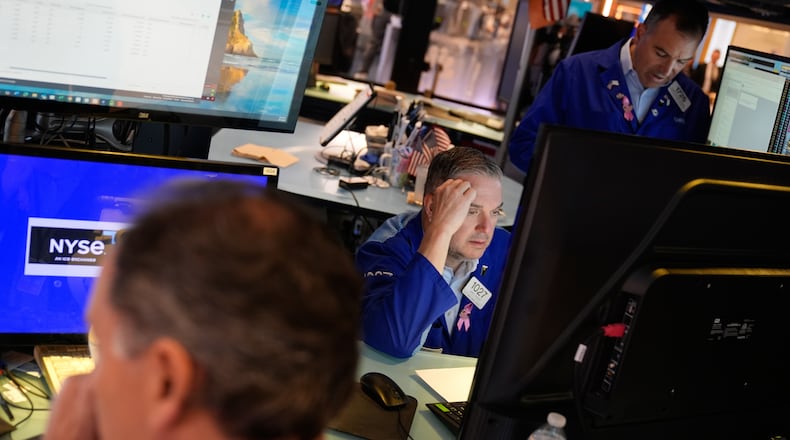 James Bodner, center, and others work on the floor at the New York Stock Exchange in New York, Wednesday, Oct. 1, 2025. (AP Photo/Seth Wenig)