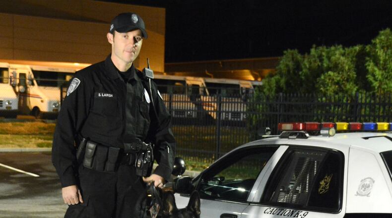 Fairfield Police Officer Sam Larsh is the newest K-9 handler for the city of Fairfield. He and his partner, Scout, a black German Shepherd, is the third active K-9 unit for the city police department. MICHAEL D. PITMAN/STAFF