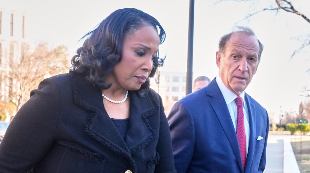 Federal Reserve governor Lisa Cook and attorney Abbe Lowell, arrive at the Supreme Court in Washington, Wednesday, Jan. 21, 2026. (AP Photo/Mark Schiefelbein)