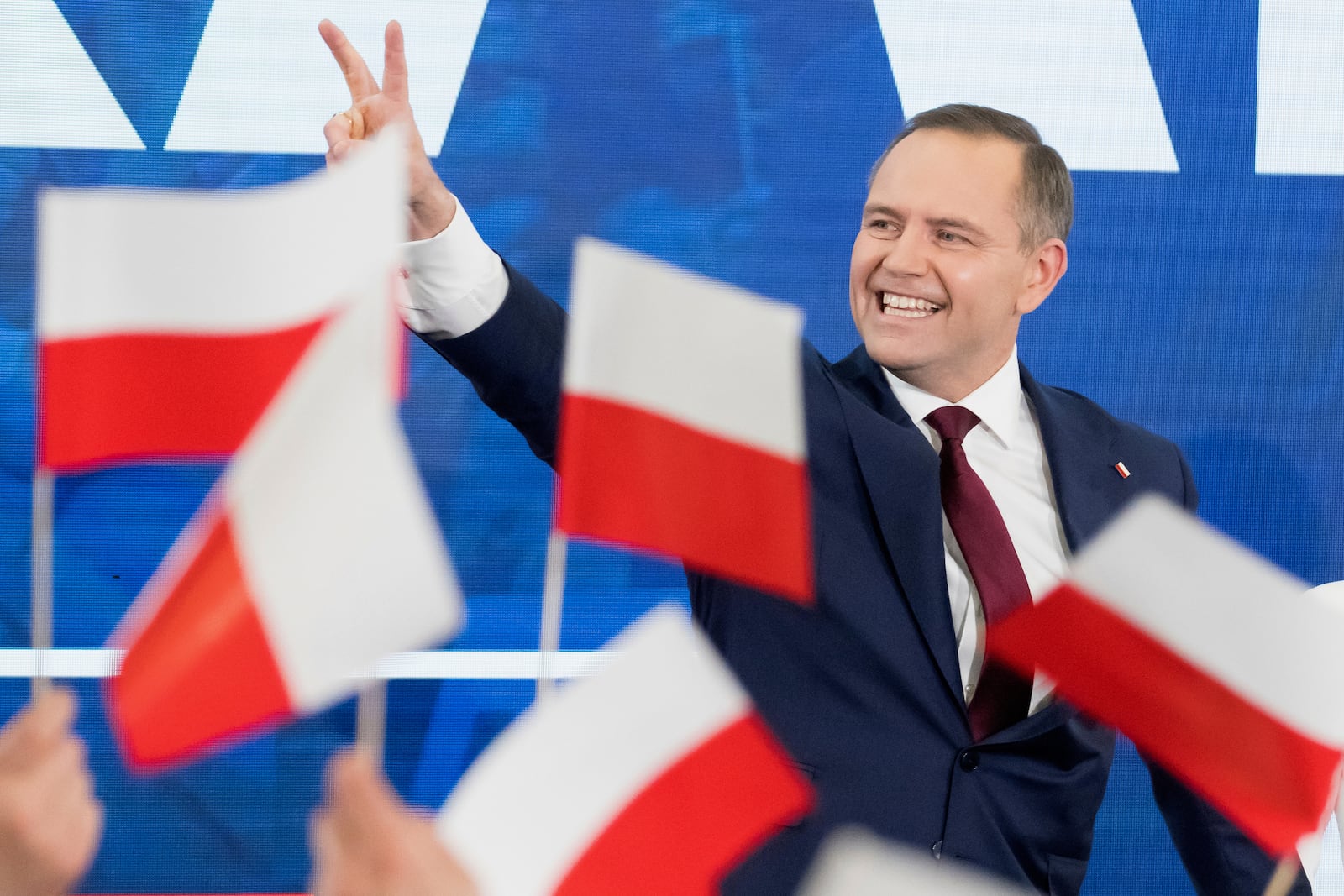 Karol Nawrocki, presidential candidate for the 2025 Polish presidential election supported by Poland's national conservative Law and Justice party, waves to supporters as first exit polls following presidential elections are announced in Gdansk, Poland, Sunday, May 18, 2025. (AP Photo/Wojciech Strozyk)