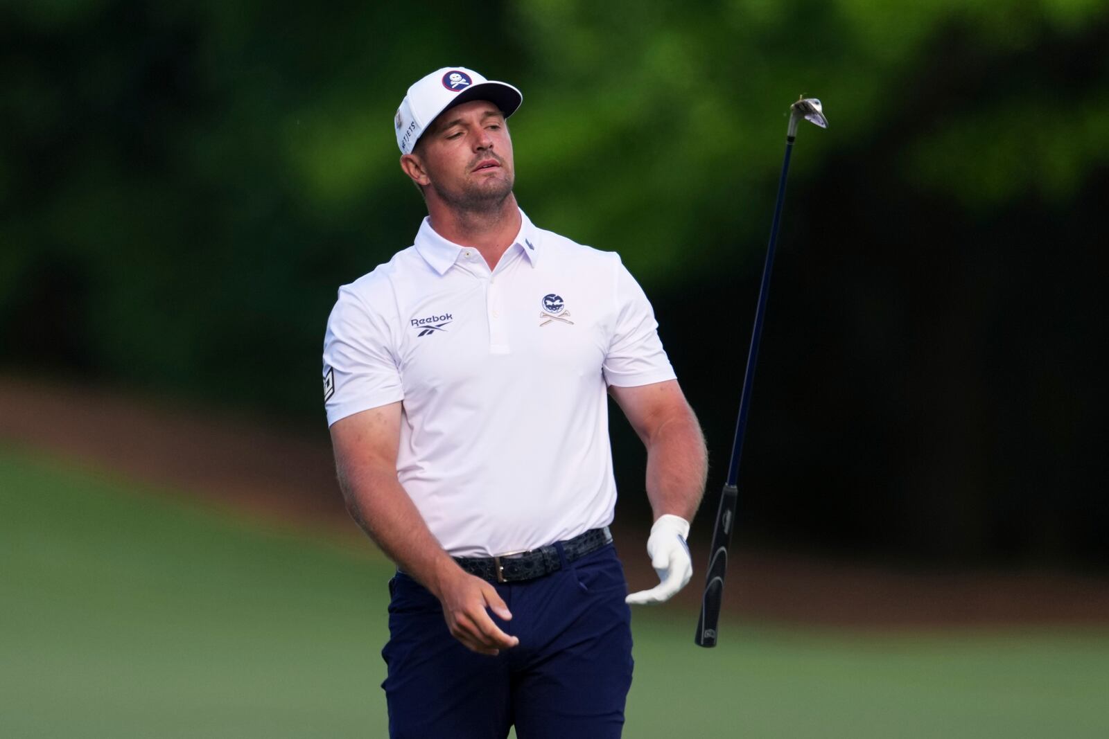 Bryson DeChambeau tosses his club on the 12th hole during the third round at the Masters golf tournament, Saturday, April 12, 2025, in Augusta, Ga. (AP Photo/Matt Slocum)