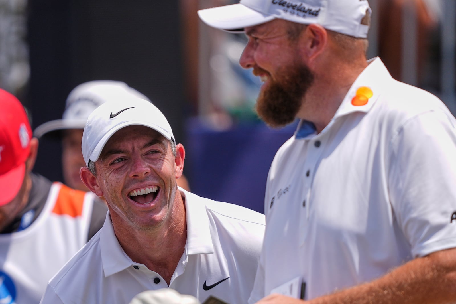 Rory McIlroy, of North Ireland, left, reacts as he and teammate Shane Lowry, of Ireland, ready to tee of the first hole during the final round of the PGA Zurich Classic golf tournament at TPC Louisiana in Avondale, La., Sunday, April 27, 2025. (AP Photo/Gerald Herbert)