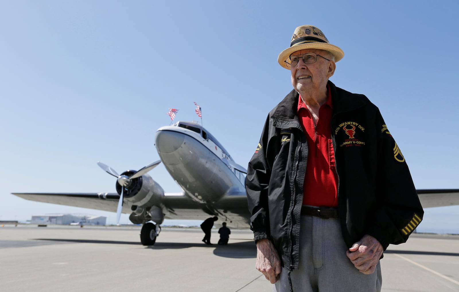 FILE - In this photo taken April 29, 2019, D-Day veteran Jake Larson poses before going for a ride in the "The Spirit of Benovia" World War II-era aircraft in Oakland, Calif. (AP Photo/Eric Risberg, file)