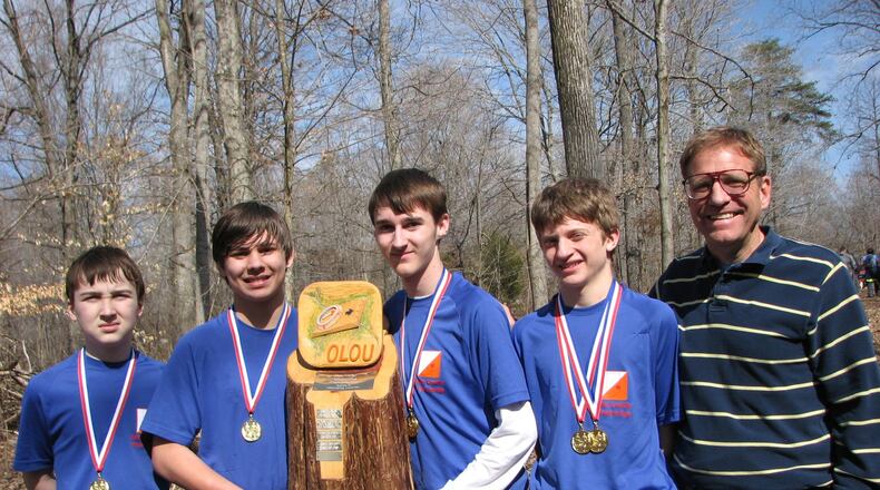 Mike Minium (right) with students holding the Ohio Valley School Orienteering Championship trophy. CONTRIBUTED