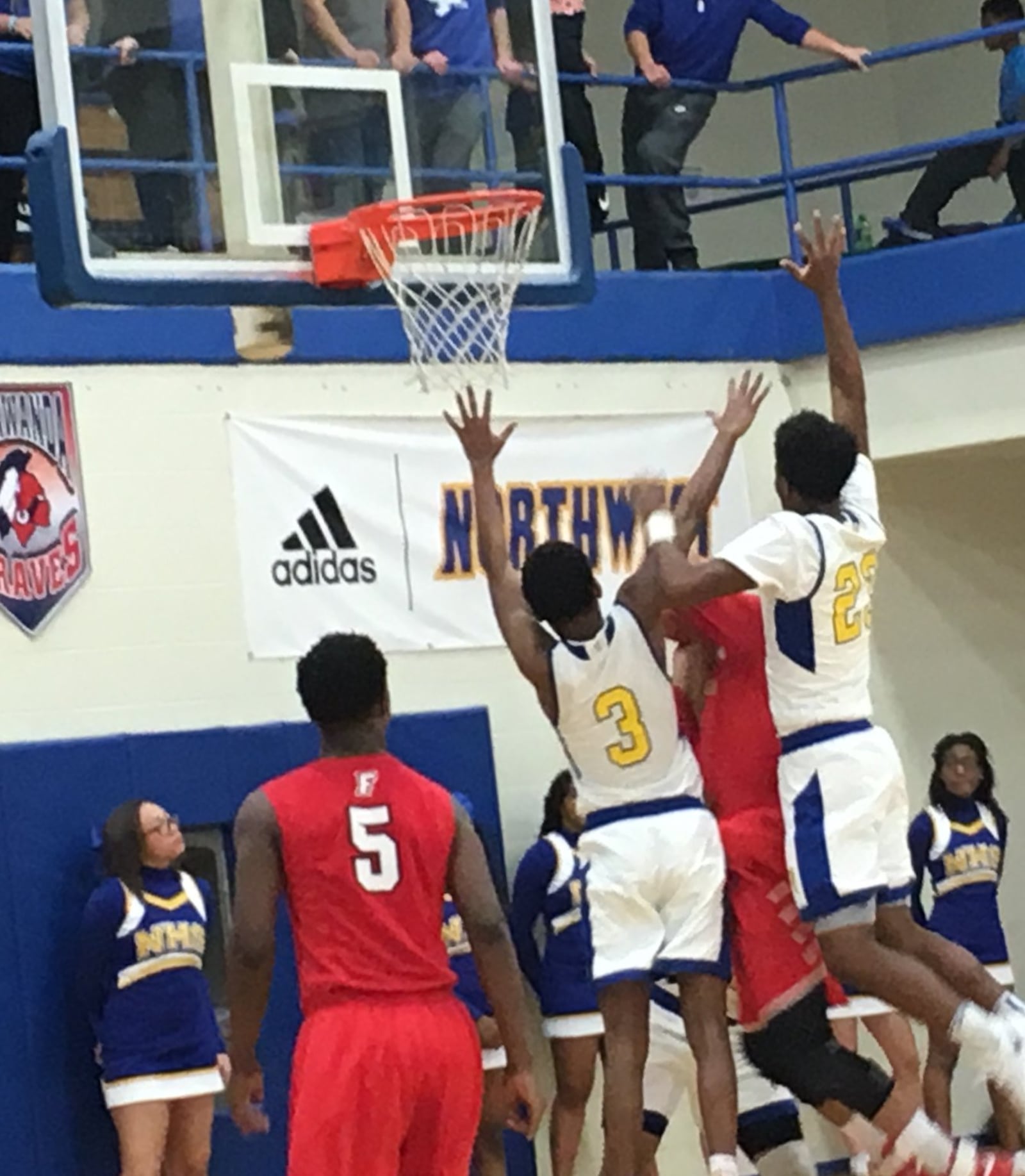 Northwest’s Tyre McKinney (3) and Kaleb Williams (23) go up for a block against Fairfield’s Isaiah Phillips (4) as teammate Jeff Tyus (5) watches during Tuesday night’s 58-44 win by the host Knights in Colerain Township. RICK CASSANO/STAFF