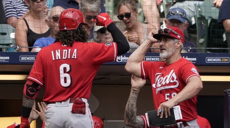 Cincinnati Reds hitting coach Alan Zinter congratlates Jonathan India on his three-run home run during the fifth inning of a baseball game against the Milwaukee Brewers Thursday, Aug. 26, 2021, in Milwaukee. (AP Photo/Morry Gash)