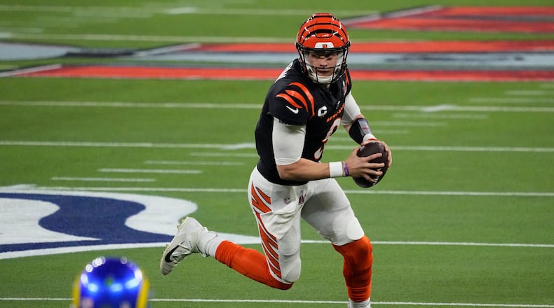 Cincinnati Bengals quarterback Joe Burrow (9) scrambles against the Los Angeles Rams during the second half of the NFL Super Bowl 56 football game Sunday, Feb. 13, 2022, in Inglewood, Calif. (AP Photo/Elaine Thompson)