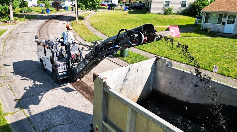 City of Hamilton street crew grinds a section of Weinman Dr. with their new milling machine before repaving Tuesday, June 25, 2024. NICK GRAHAM/STAFF