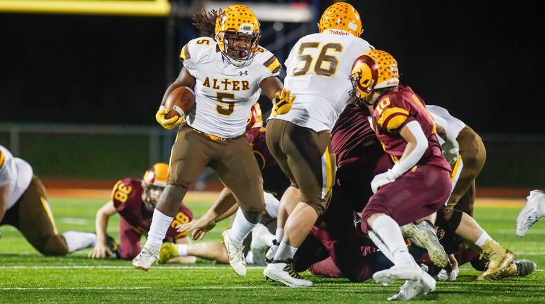 Cutline 1: Alter High School running back Branden McDonald runs against the Ross defense during their Division III regional final game on Friday night. The Knights won 35-21. Micahel Cooper/CONTRIBUTED