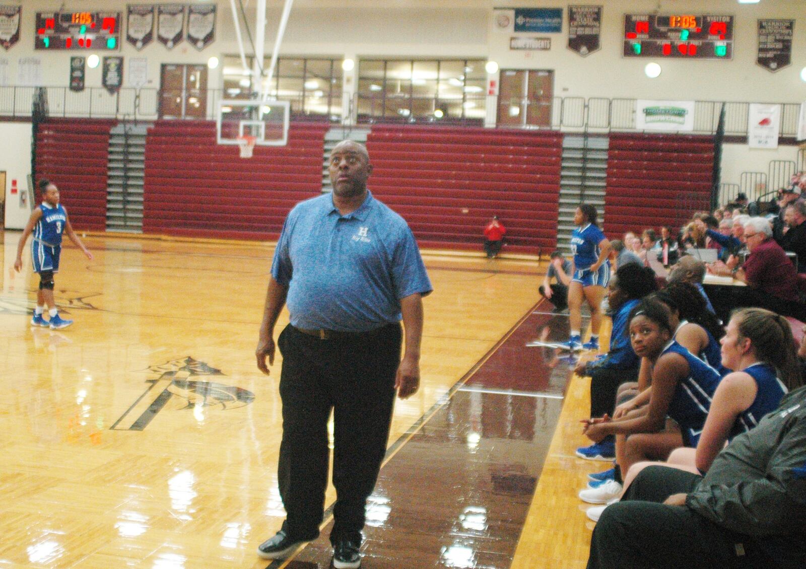 Hamilton coach Harry Phillips glances up at a scoreboard late in the first half of Monday night’s game at Lebanon. Phillips’ Big Blue won 52-42. RICK CASSANO/STAFF