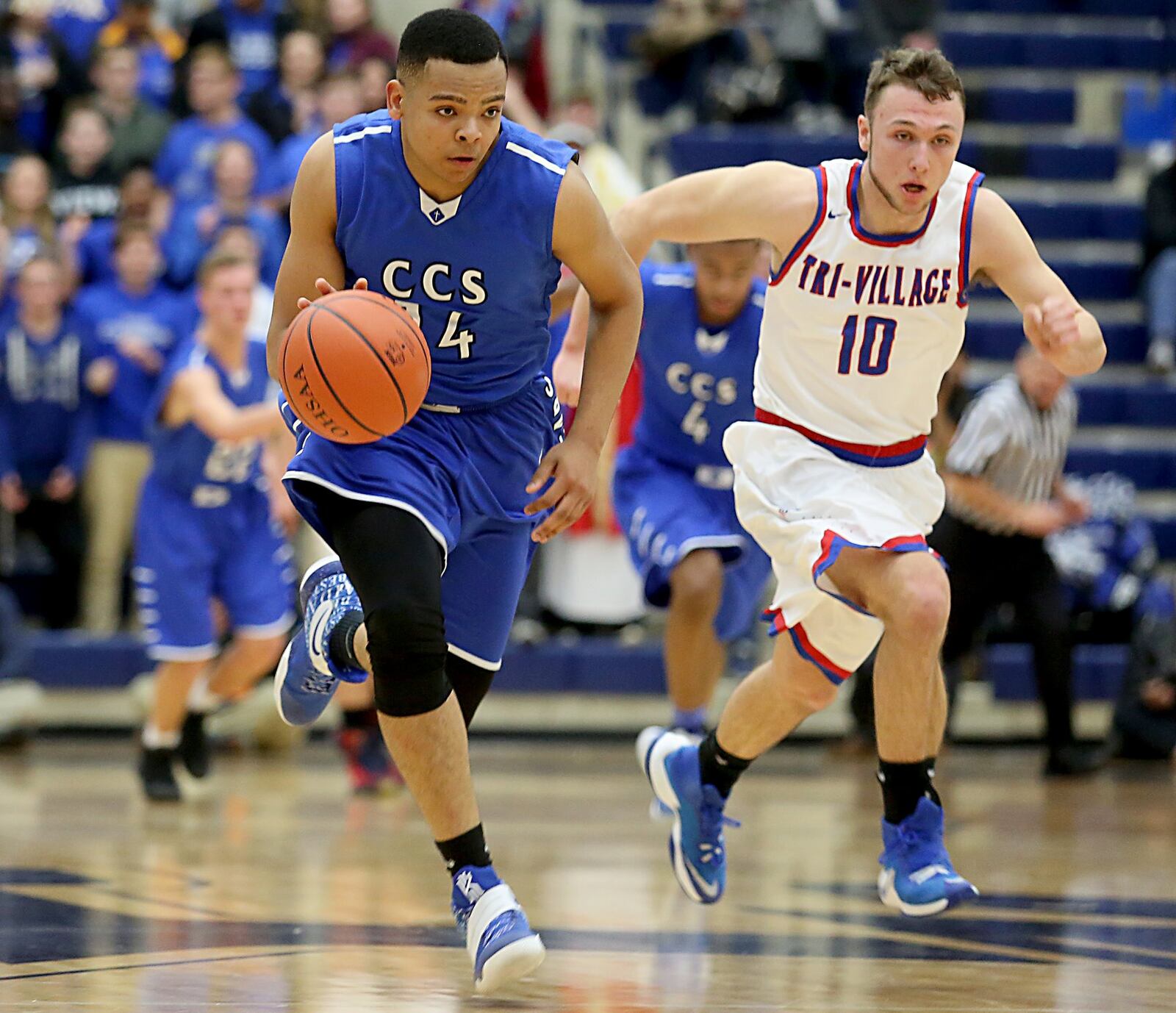 Cincinnati Christian’s Christian Keese beat New Madison Tri-Village’s Jonny Wilson up the floor Tuesday night during their Division IV regional semifinal at Fairmont’s Trent Arena. CONTRIBUTED PHOTO BY E.L. HUBBARD