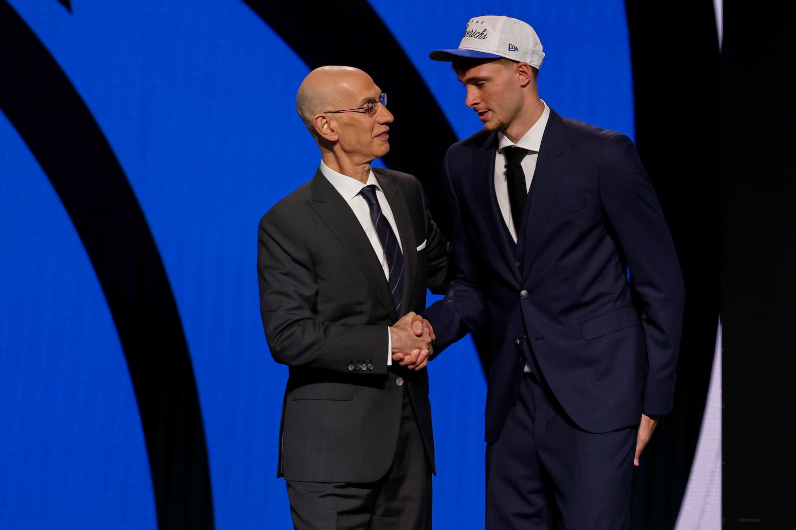Cooper Flagg, right, shakes hands with NBA commissioner Adam Silver after being selected first overall by the Dallas Mavericks In the first round of the NBA basketball draft, Wednesday, June 25, 2025, in New York. (AP Photo/Adam Hunger)
