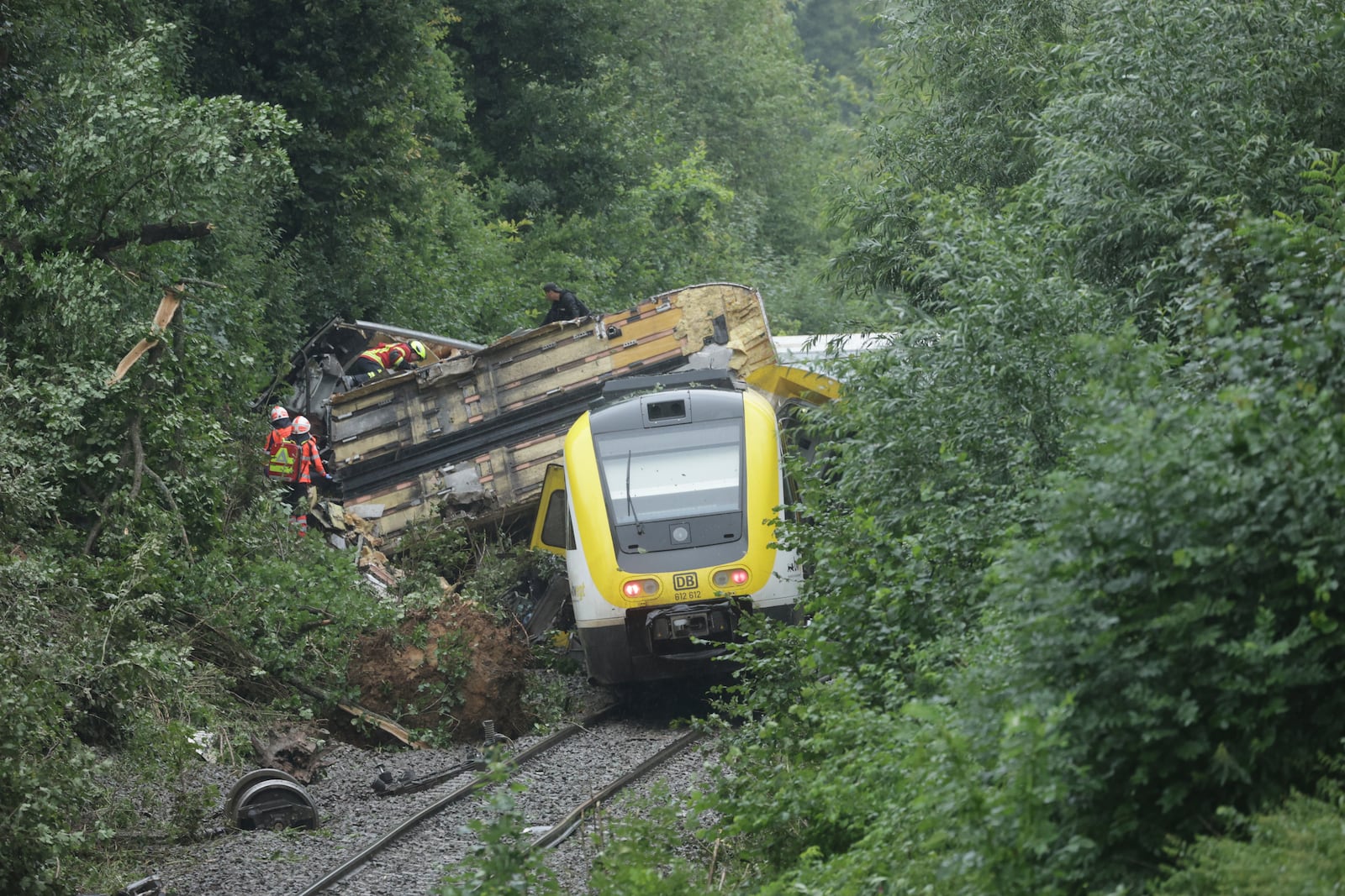 Rescue workers search for passengers in a derailed train, Zwiefaltendorf, Sunday July 27, 2025. (Thomas Warnack/dpa via AP)