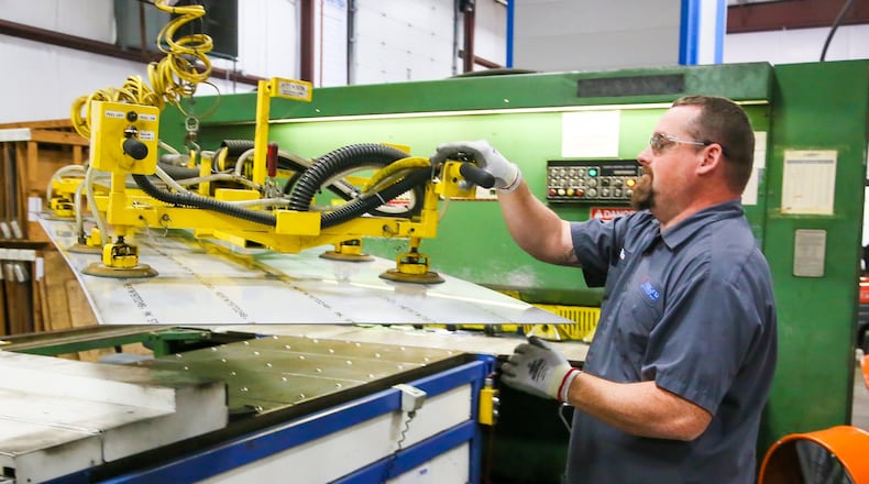 Mike Guffey works on a shearing machine at United Performance Metals in Hamilton, Wednesday, Sept. 6, 2017. GREG LYNCH / STAFF