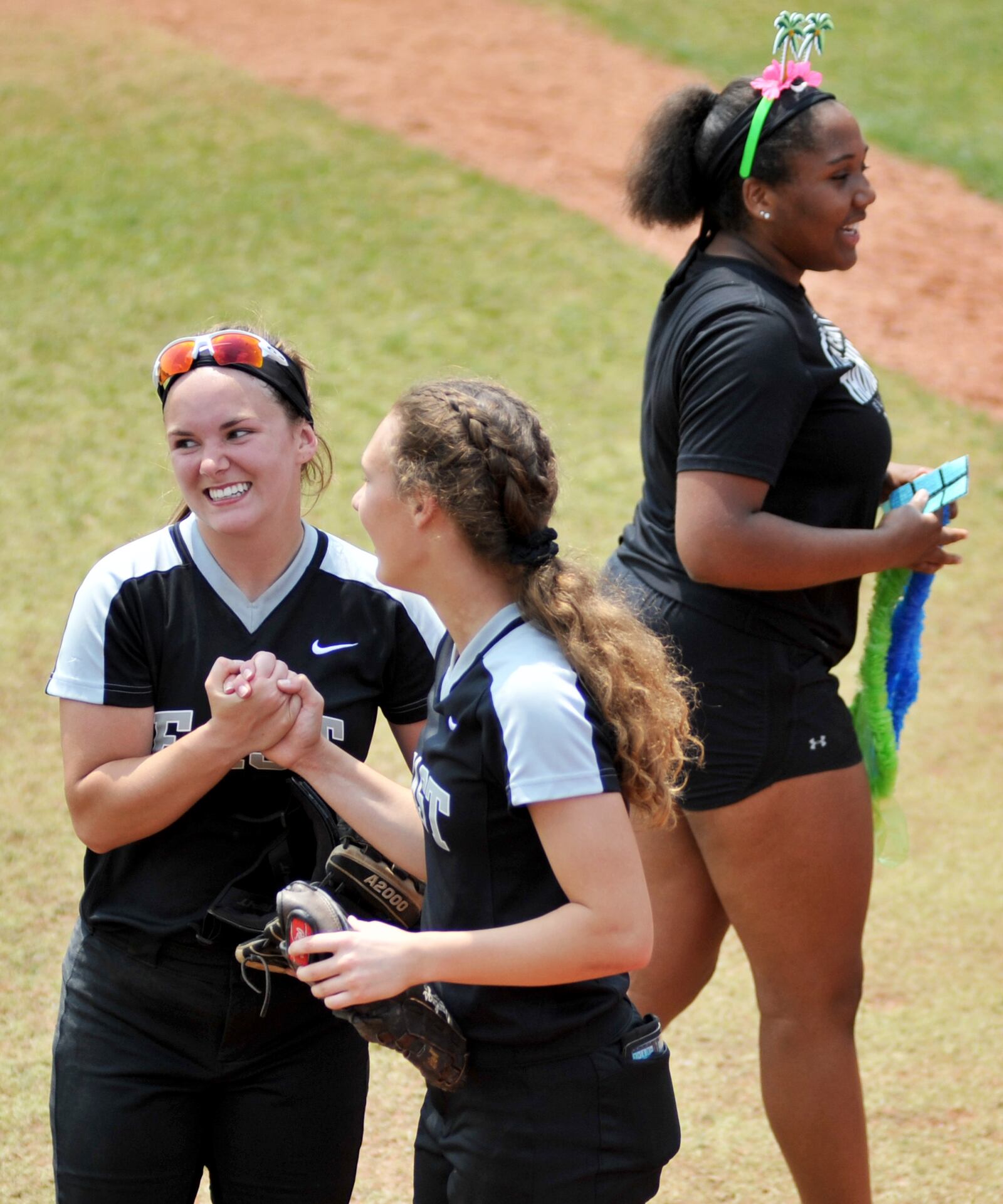 Lakota East’s Sydney Larson (left) and Kylee West celebrate Friday after their Division I state softball semifinal against Westerville Central at Firestone Stadium in Akron. East won 4-3. RICK CASSANO/STAFF