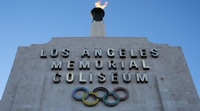 The Olympic cauldron is lit at the Los Angeles Memorial Coliseum ahead of the launch for ticket registration to the 2028 Summer Olympic Games Tuesday, Jan. 13, 2026, in Los Angeles. (AP Photo/Damian Dovarganes)