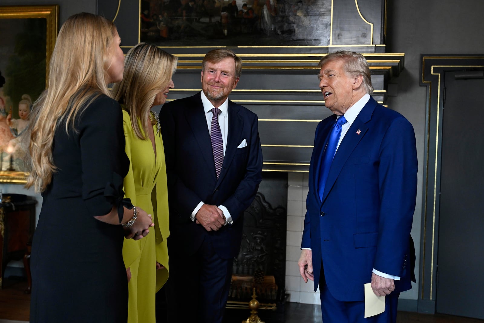 President Donald Trump, right, is welcomed by Netherland's King Willem Alexander, Netherland's Queen Maxima and Netherland's Crown Princess Amalia as he arrives for a formal dinner at the Paleis Huis ten Bosch ahead of the NATO summit in The Hague, Netherlands, Tuesday, June 24, 2025. (Misha Schoemakers, Pool Photo via AP)