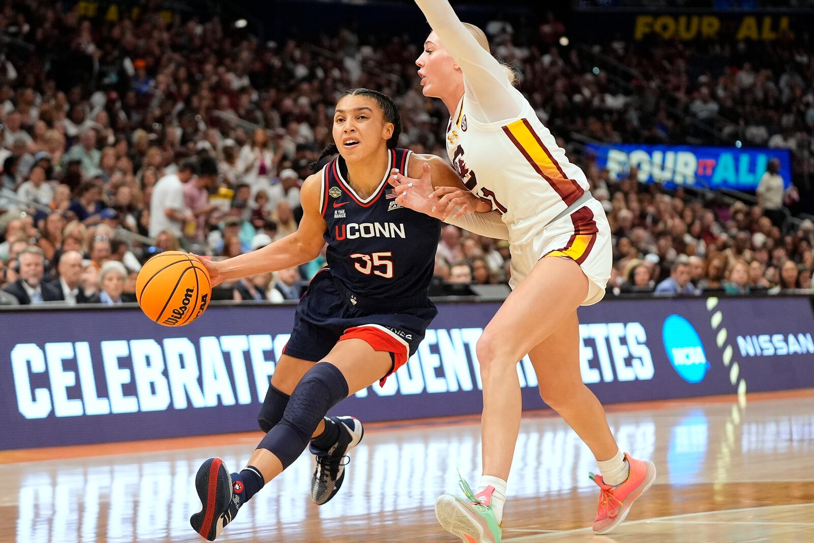 UConn guard Azzi Fudd (35) drives to the basket against South Carolina forward Chloe Kitts (21) during the second half of the national championship game at the Final Four of the women's NCAA college basketball tournament, Sunday, April 6, 2025, in Tampa, Fla. (AP Photo/John Raoux)